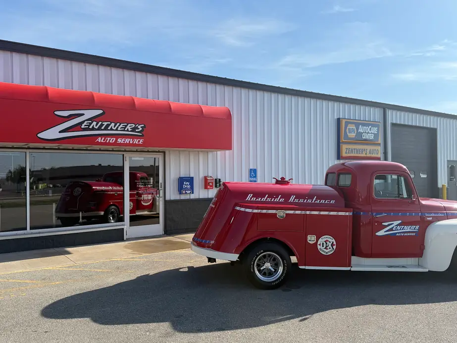 Zentner's restored red 1950s Roadside Assistance truck parked under the red awning at the Greenville Drive shop